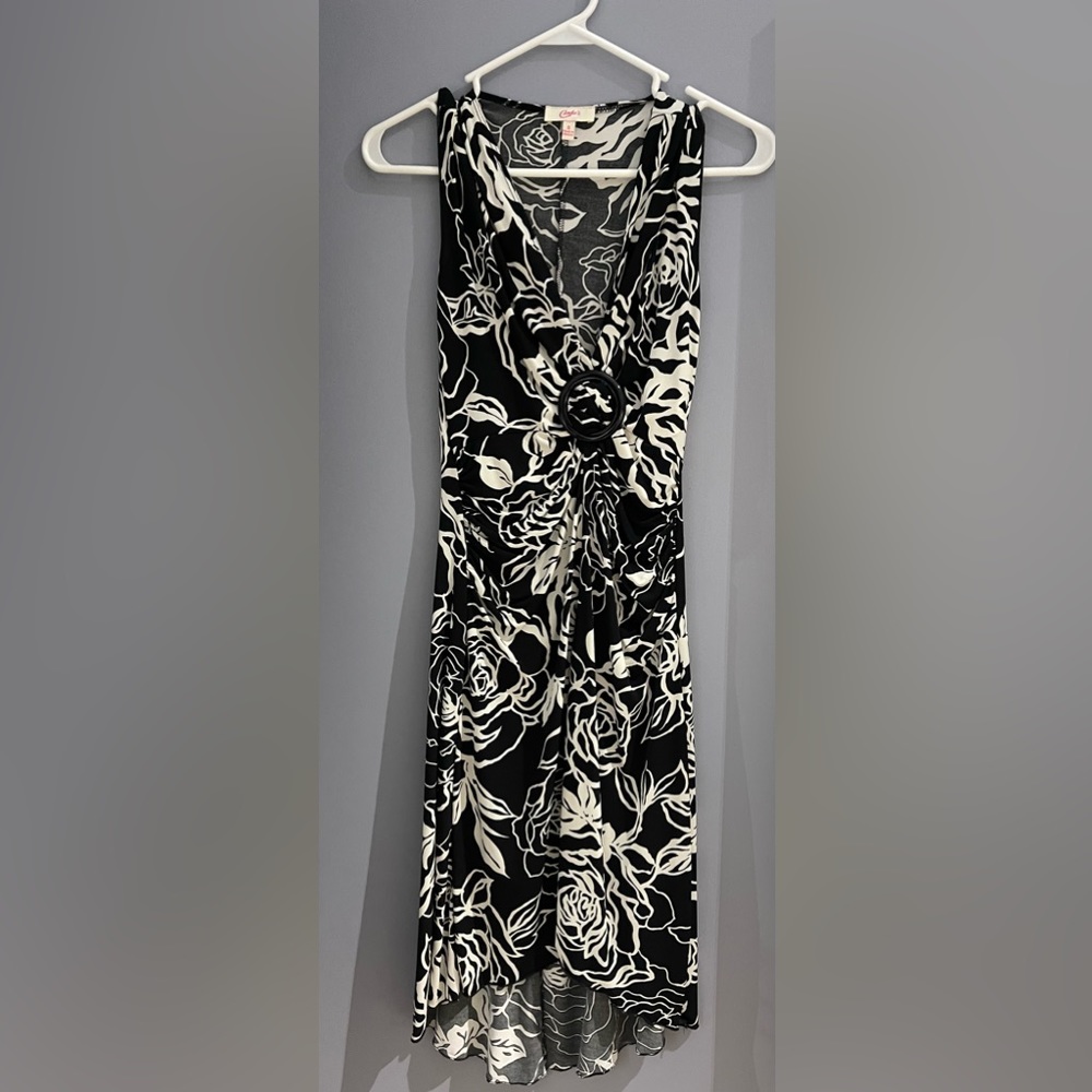 Black printed nylon fabric dress. Falls just below the knee. Free flowing soft